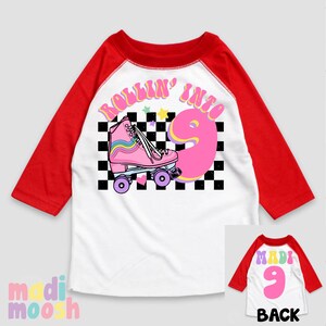 May include: White and red baseball tee shirt with a pink roller skate and the text "Rollin' into 9" on the front. The back of the shirt has a pink number 9.