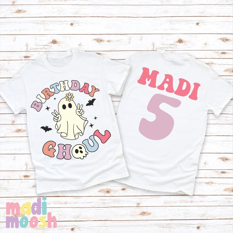 May include: White t-shirt with a ghost wearing a flower crown and the text "Birthday Ghoul" in rainbow colours. The back of the shirt has the name "MADI" and the number "5" in pink.