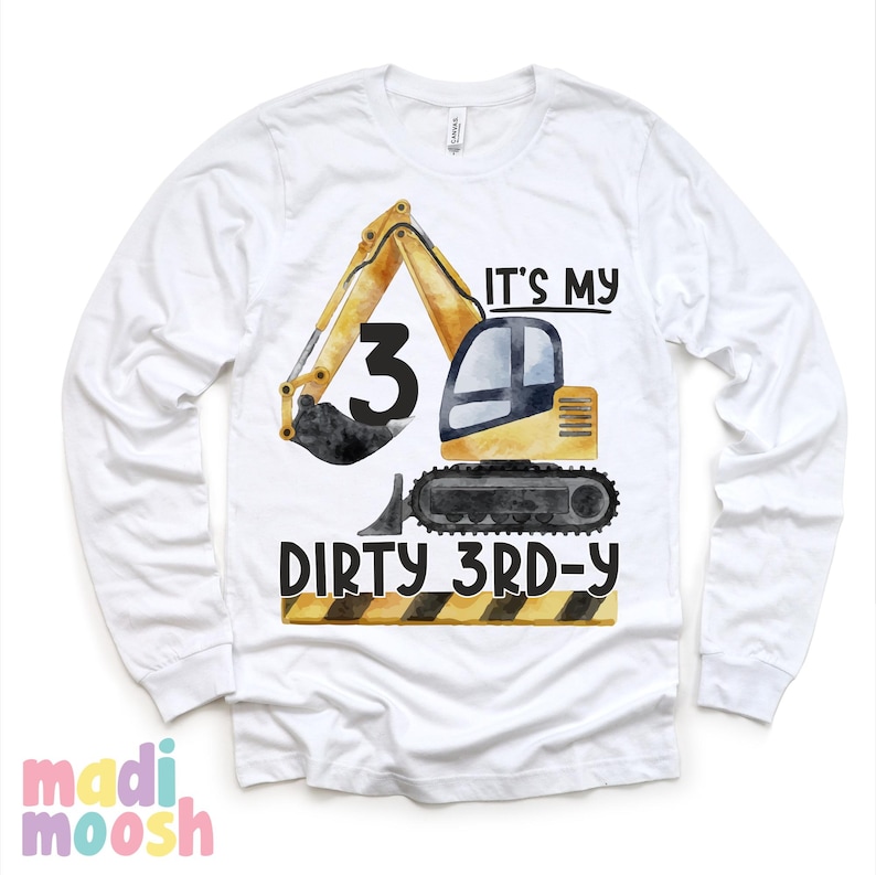 May include: White long-sleeve t-shirt with a yellow excavator graphic and the text "It's my 3rd-y Dirty 3rd-y".