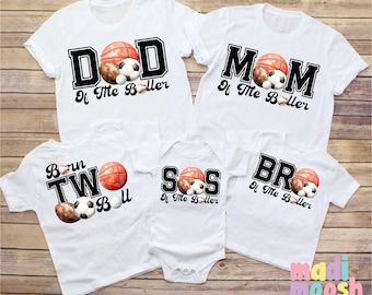 May include: White t-shirts with black text and sports ball graphics. The shirts read "DAD of the baller", "MOM of the baller", "Born to Ball", "SIS of the baller", and "BRO of the baller".
