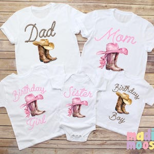 May include: Set of five white t-shirts with pink and brown cowboy boot and hat designs. The shirts say "Dad", "Mom", "Birthday Girl", "Birthday Boy", and "Sister".