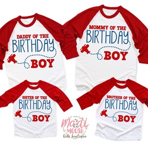 May include: Four red and white baseball-style shirts with blue text that reads "Mommy of the Birthday Boy", "Daddy of the Birthday Boy", "Sister of the Birthday Boy", and "Brother of the Birthday Boy". Each shirt features a small red airplane graphic with a blue dotted line.