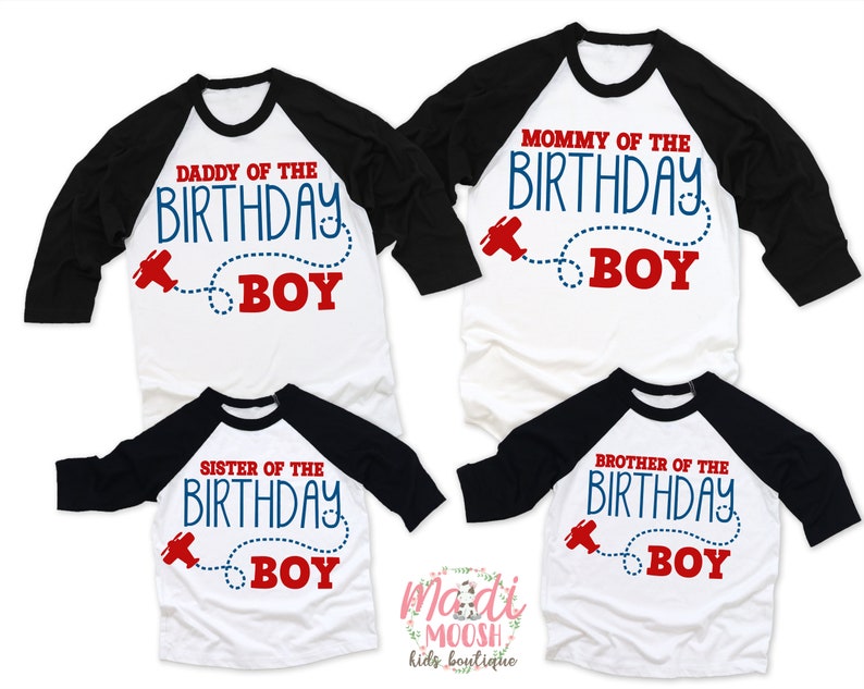 May include: Set of four white and black baseball shirts with red and blue text. The shirts say "Mommy of the Birthday Boy", "Daddy of the Birthday Boy", "Sister of the Birthday Boy", and "Brother of the Birthday Boy". Each shirt has a small red airplane graphic with a blue dotted line.