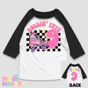 May include: White and black baseball tee shirt with a pink roller skate and the text "Rollin' into 9". The back of the shirt has a pink number 9.