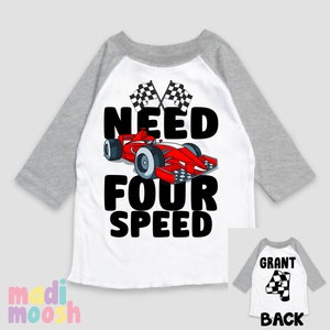 May include: White and grey baseball style t-shirt with a red race car and the text "Need Four Speed". The back of the shirt has the text "Grant" and a checkered flag with the number 4.