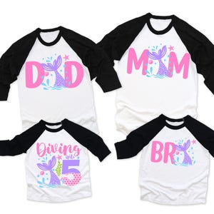 May include: Set of four white and black baseball shirts with pink and purple mermaid designs. The shirts say "Dad", "Mom", "Diving into 5", and "Bro".