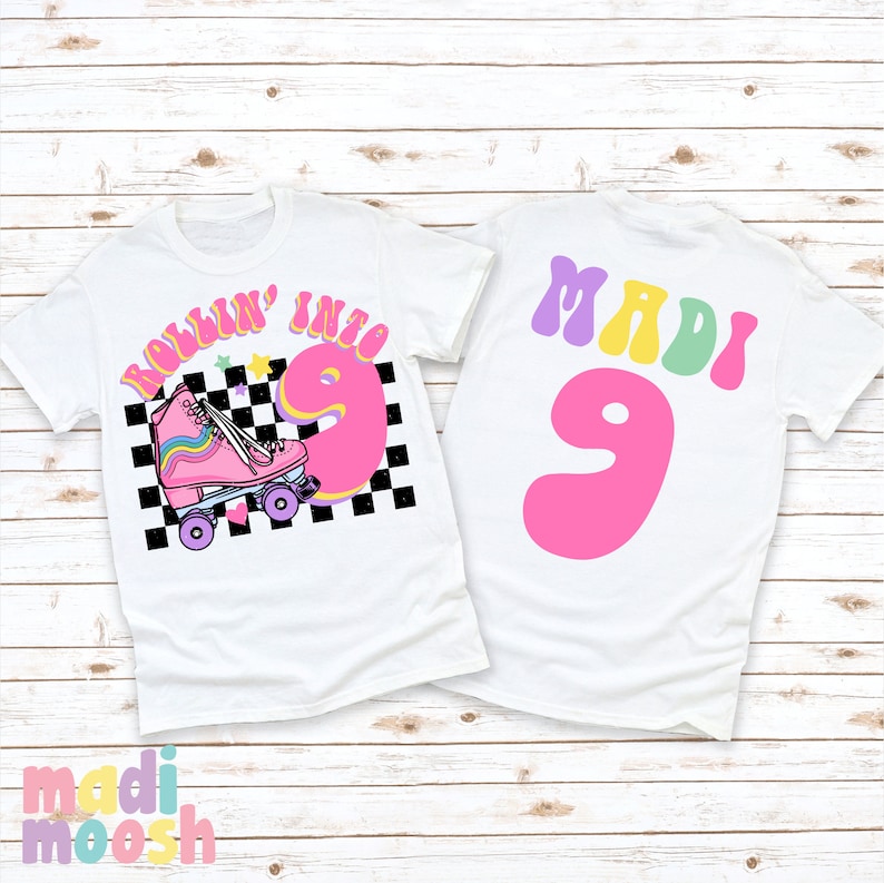 May include: Two white t-shirts with a roller skate design. The front shirt has a pink roller skate with rainbow laces and the text "Rollin' into 9". The back shirt has the text "MADI 9" in colorful letters.