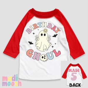May include: White and red baseball style t-shirt with a ghost and the text "Birthday Ghoul". The text is in rainbow colours. The back of the shirt is red with the text "Madi 5" in pink.