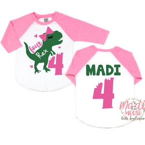May include: Two white and pink baseball shirts with a green dinosaur graphic and the text "four Rex 4" on the front and the text "MADI 4" on the back.