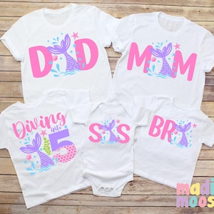 May include: Set of five white t-shirts with pink and purple mermaid tail designs. The shirts say "Dad", "Mom", "Sis", "Bro", and "Diving into 5".