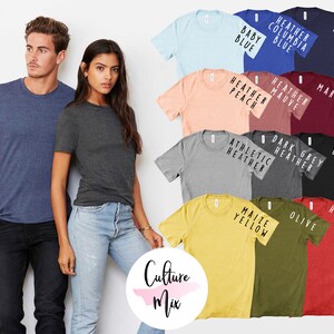 May include: A variety of t-shirts in different colors, including navy, maroon, black, olive, heather red, maize yellow, athletic heather, dark heather grey, heather peach, heather mauve, and baby blue. The shirts are all short-sleeved and have a crew neck. The text on the shirts includes "Heather Columbia Blue", "Navy", "Maroon", "Heather Mauve", "Heather Peach", "Dark Grey Heather", "Athletic Heather", "Black", "Olive", "Heather Red", "Maize Yellow", and "Baby Blue".