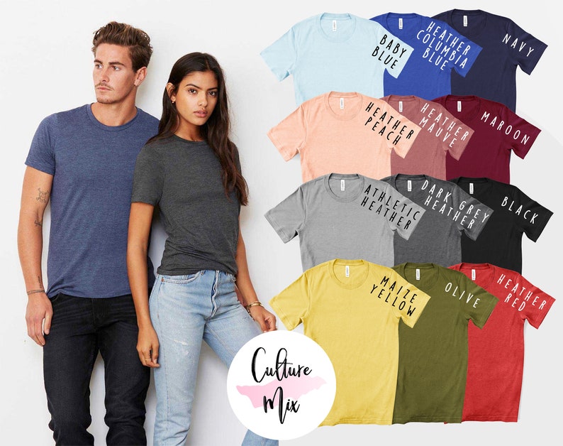 May include: A variety of t-shirts in different colors, including navy, maroon, black, olive, heather red, maize yellow, athletic heather, dark heather grey, heather peach, heather mauve, and baby blue. The shirts are all short-sleeved and have a crew neck. The text on the shirts includes "Heather Columbia Blue", "Navy", "Maroon", "Heather Mauve", "Heather Peach", "Dark Grey Heather", "Athletic Heather", "Black", "Olive", "Heather Red", "Maize Yellow", and "Baby Blue".