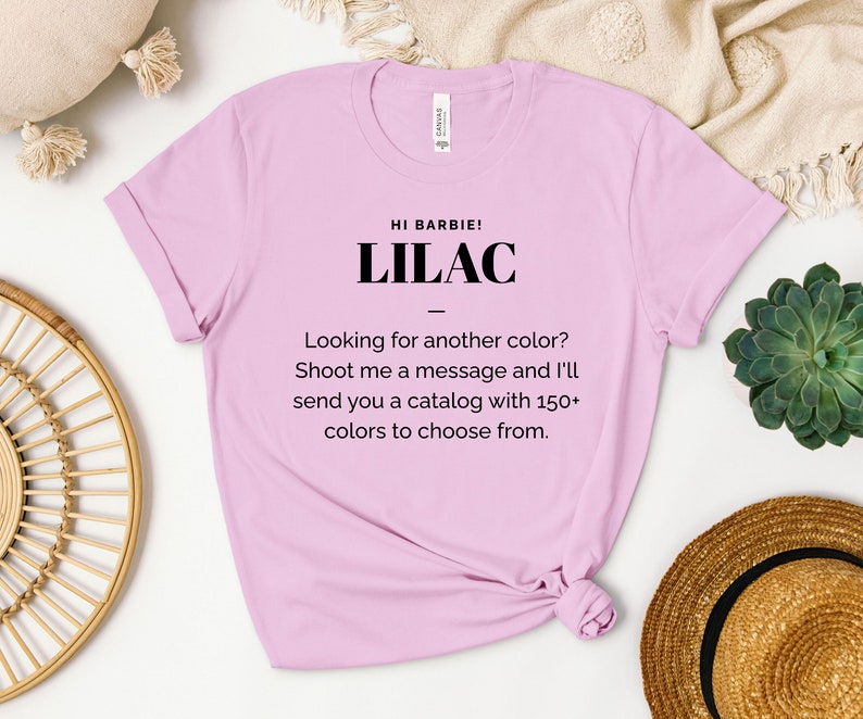 May include: A light pink t-shirt with the text "HI BARBIE! LILAC" and the message "Looking for another color? Shoot me a message and I'll send you a catalog with 150+ colors to choose from."