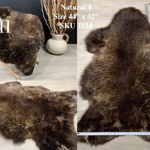May include: A brown sheepskin rug with long, soft fur. The rug is 44 inches by 32 inches and is labeled "Natural 4, SKU 7154".