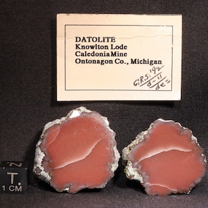 May include: Two red and white datolite specimens from the Knowlton Lode, Caledonia Mine, Ontonagon Co., Michigan. The specimens are approximately 5 cm in diameter and have a banded pattern.