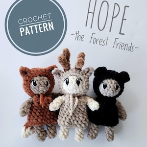 May include: Three crocheted forest animal dolls: a bear in brown, a deer in beige, and a bear in black. Each doll has a hood and a friendly face. The image includes the text "HOPE - the Forest Friends-" and "CROCHET PATTERN".