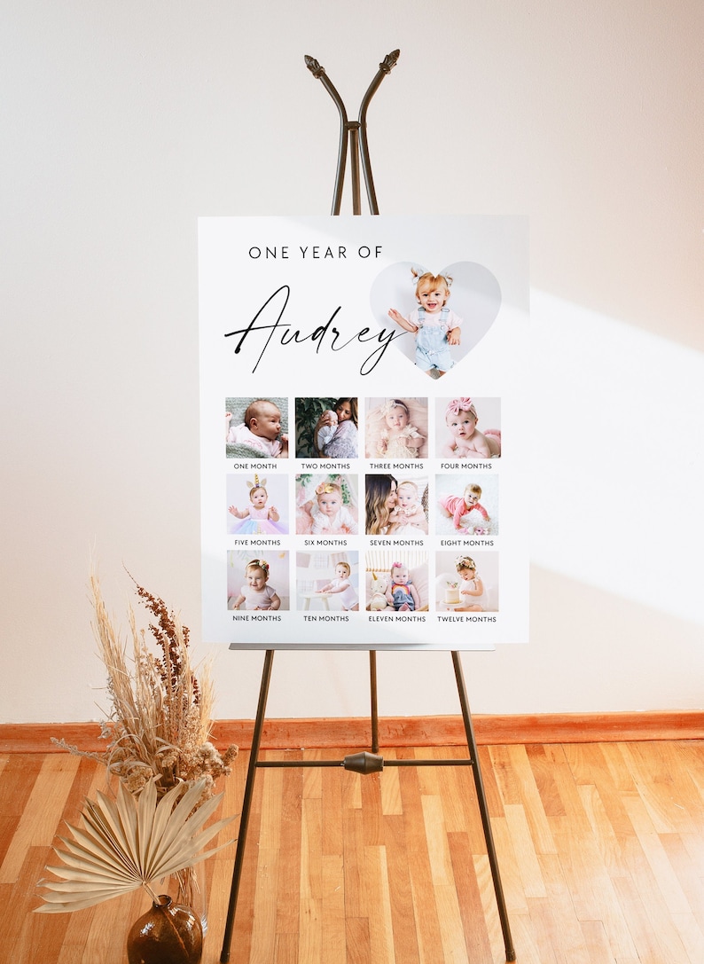 Puede incluir: Un tablero blanco con una foto en forma de coraz&oacute;n de una ni&ntilde;a peque&ntilde;a en la parte superior. El tablero est&aacute; dividido en 12 cuadrados, cada uno con una foto de la ni&ntilde;a a una edad diferente. El texto "ONE YEAR OF Audrey" est&aacute; en la parte superior del tablero. Cada cuadrado tiene la edad de la ni&ntilde;a en meses escrita debajo de la foto.