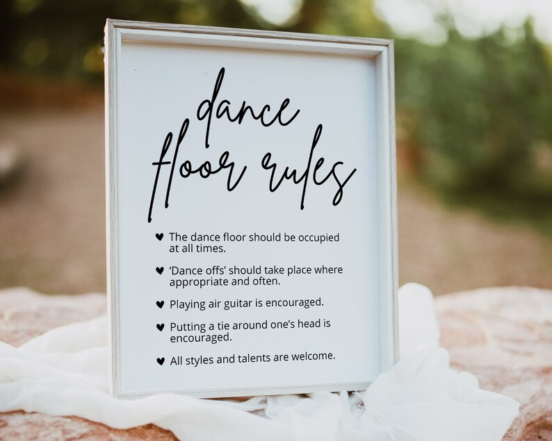 May include: White sign with black text that reads "dance floor rules". The rules are: The dance floor should be occupied at all times. 'Dance offs' should take place where appropriate and often. Playing air guitar is encouraged. Putting a tie around one's head is encouraged. All styles and talents are welcome.
