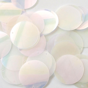 May include: A collection of iridescent, round sequins. The sequins are a pale, translucent color with a subtle sheen, reflecting hints of pastel hues. Each sequin has a small hole for stringing or sewing, ideal for craft projects.