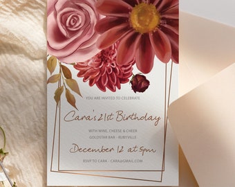 May include: A floral-themed invitation with a gold frame. The text reads "You are invited to celebrate Cara's 21st Birthday with wine, cheese & cheer Goldstar Bar - Rubyville December 12 at 5pm RSVP to Cara - cara@gmail.com"