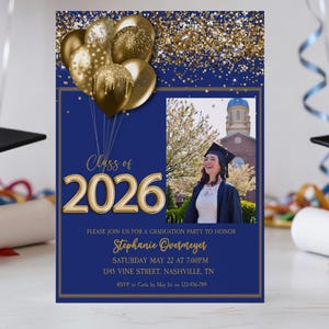 May include: A navy blue graduation party invitation with gold accents. The invitation features the text "Class of 2026" and a photo of a graduate. Gold balloons and confetti decorate the top. The invitation includes party details.