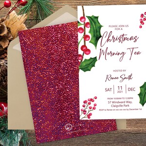 May include: A white invitation card featuring watercolour holly leaves and red berries with the text Christmas Morning Tea hosted by Renee Smith on Saturday December 11 2021. The card is paired with a textured dark red envelope.