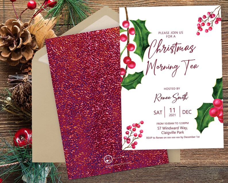 May include: A white invitation card featuring watercolour holly leaves and red berries with the text Christmas Morning Tea hosted by Renee Smith on Saturday December 11 2021. The card is paired with a textured dark red envelope.