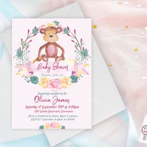 May include: Pink baby shower invitation with a watercolor illustration of a monkey wearing a flower crown. The text reads "Baby Shower Please join us honoring mother-to-be Olivia James Saturday 12 September 2019 at 4:00pm 1230 Wilson Boulevard, Riverstone Olivia is registered at Target, Macy's & Amazon RSVP by 5 September to Marie on III-II-III"