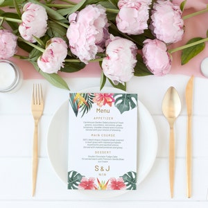 May include: A tropical-themed wedding menu card with a floral design. The menu includes appetizers, main course, and dessert. The card is printed on white cardstock and features a gold border. The text on the card reads "Menu", "Appetizer", "Farmhouse Garden Salad", "Main Course", "100% Black Angus Chopped Steak", "Dessert", "Double Chocolate Fudge Cake", "Ice Cream", "S & J", "19.7.19".