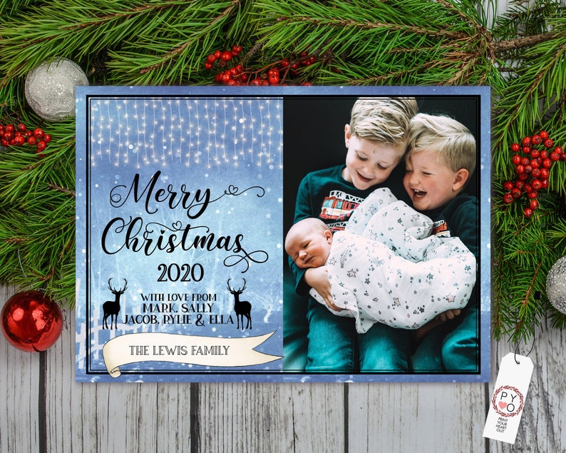 May include: A Christmas card with a blue background and the text "Merry Christmas 2020". The card includes a family photo and the names of the family members. The card is decorated with deer silhouettes and a banner that reads "THE LEWIS FAMILY".
