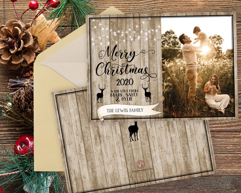 May include: Christmas card with a family photo and wooden background. The card reads "Merry Christmas 2020" with the family name. The photo shows a family of three in a field. The card is in an envelope.