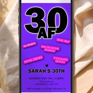 May include: A smartphone displays a purple birthday invitation for "Sarah's 30th." The design features bold black text, including "30 AF," and playful phrases like "Bring Drinks" and "Bad Decisions Pending."