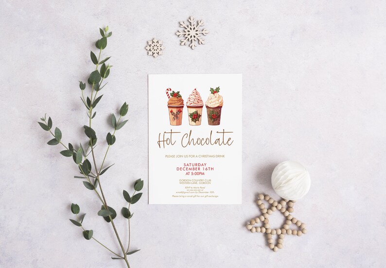 May include: A Christmas-themed invitation with three illustrated hot chocolate cups, topped with whipped cream and festive decorations. The words "Hot Chocolate" are written in elegant script. Decorative elements include snowflakes and greenery.