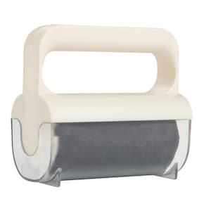 May include: A cream-coloured lint roller with a grey roller. The roller has a handle for easy use. The roller is designed to remove lint, pet hair, and other debris from clothing and fabric surfaces.