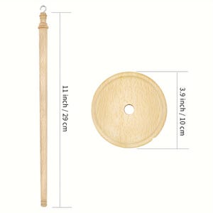 May include: A wooden towel rod with a round base and a hook at the top. The rod is 11 inches / 29 cm long and the base is 3.9 inches / 10 cm in diameter.
