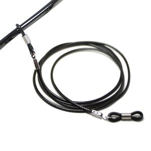 May include: Black eyeglass chain with silver metal clasps and rubber ends. The chain is coiled and ready to be worn.