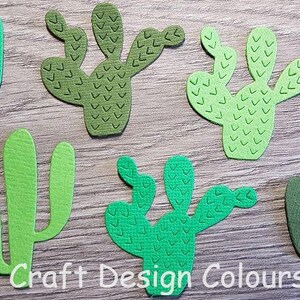 May include: Six die-cut cactus shapes in various shades of green, including light, medium, and dark tones. Some feature embossed V-shaped patterns, while others have a smooth texture. The text Craft Design Colours is printed at the bottom.