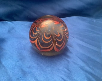 Dome-shaped paperweight - smokey clear glass with orange design