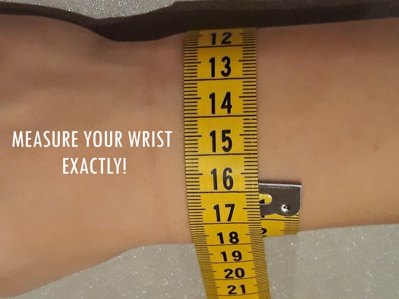 May include: A yellow measuring tape is wrapped around a wrist to measure its circumference. The tape shows measurements from 12 to 21 inches. Text on the image reads: MEASURE YOUR WRIST EXACTLY!