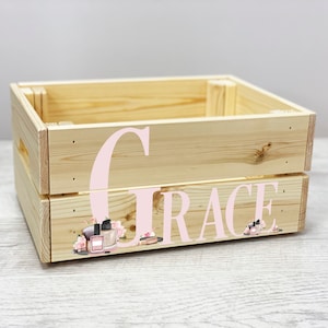 May include: A wooden crate with a pink floral design and the name "Grace" written in pink letters. The crate is perfect for storing small items.