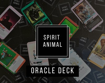 May include: A collection of Spirit Animal oracle cards scattered on a dark surface. Each rectangular card features a unique animal illustration, such as a unicorn, jaguar, hog, frog, swan, polar bear, and elephant, with descriptive text below.