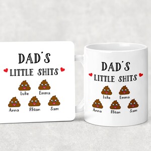 May include: A white ceramic mug and a matching square coaster, both featuring the black text DAD'S LITTLE SHITS, two red hearts, and five brown cartoon poop icons with smiling faces, each labeled with the names Luke, Emma, Anna, Rhian, and Sam.
