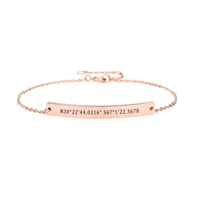 May include: A rose gold bracelet with a thin chain and a bar charm engraved with the coordinates "N30&deg;22'44.0316" S67&deg;1'22.3678".
