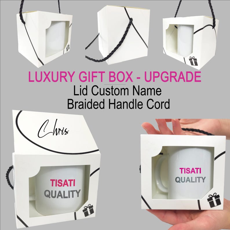 May include: A white cardboard gift box with a window, containing a white mug labeled TISATI QUALITY. The box features a black braided handle cord, a custom name Chris on the lid, and a small gift icon. Text reads LUXURY GIFT BOX - UPGRADE.