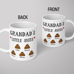 May include: Two white ceramic mugs featuring the black text GRANDAD'S LITTLE SHITS, two small red hearts, and five brown cartoon poop emojis with smiling faces. Below each emoji are the names Luke, Emma, Anna, Rhian, and Sam in black font.