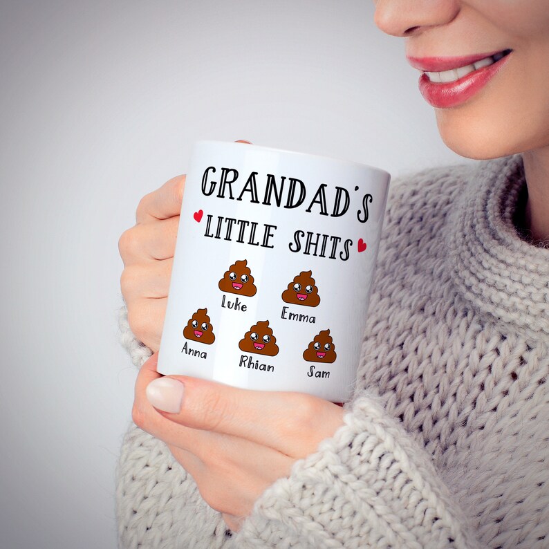 May include: White ceramic mug with the text "Grandad's Little Shits" and a heart on each side.  The mug has five cartoon poop emojis with names below each: Anna, Luke, Rhian, Emma, and Sam.