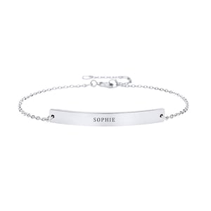 May include: A silver chain bracelet with a thin, curved bar charm engraved with the name "SOPHIE".