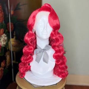 May include: A bright red wig with large, loose curls. The wig is styled in a vintage, pin-up style.
