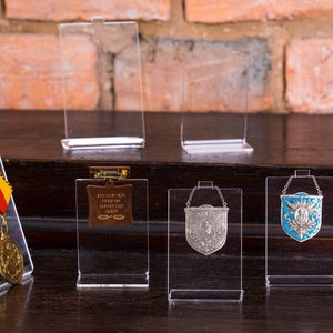 CK08 cristal display of multiple badge credentials and others fastened on a safety pin - exclusive collection