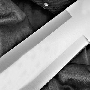 May include: A close-up of a silver knife blade with a satin finish. The blade is partially visible against a black fabric background.